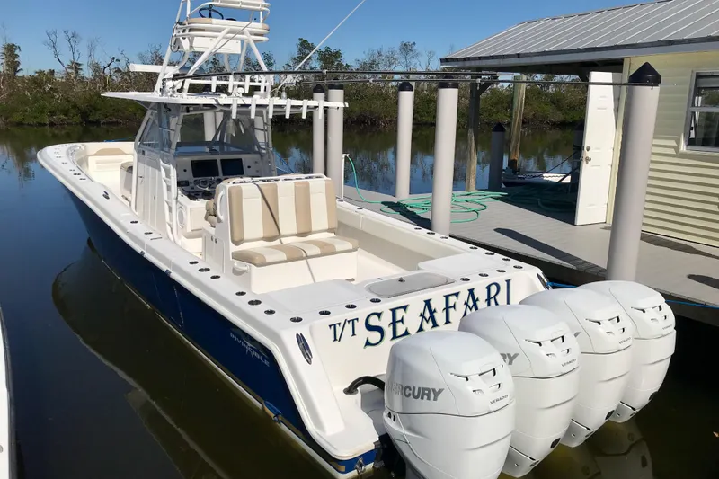 Slide: The Image of 2015 Invincible 42 Open Fisherman boat docked, featuring four Mercury engines. - 3