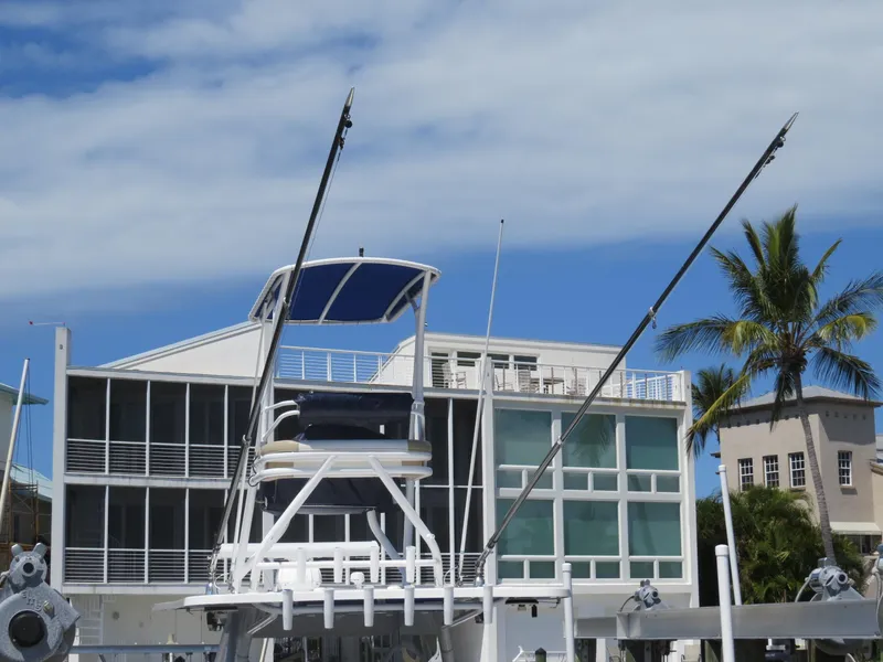 Slide: The Image of Invincible 42 Open Fisherman boat docked near modern buildings, 2015 model. - 48