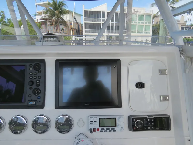 Slide: The Image of 2015 Invincible 42 Open Fisherman dashboard with navigation and control systems. - 8
