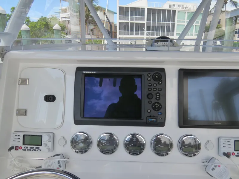 Slide: The Image of Control panel of 2015 Invincible 42 Open Fisherman boat with navigation screens and gauges. - 9