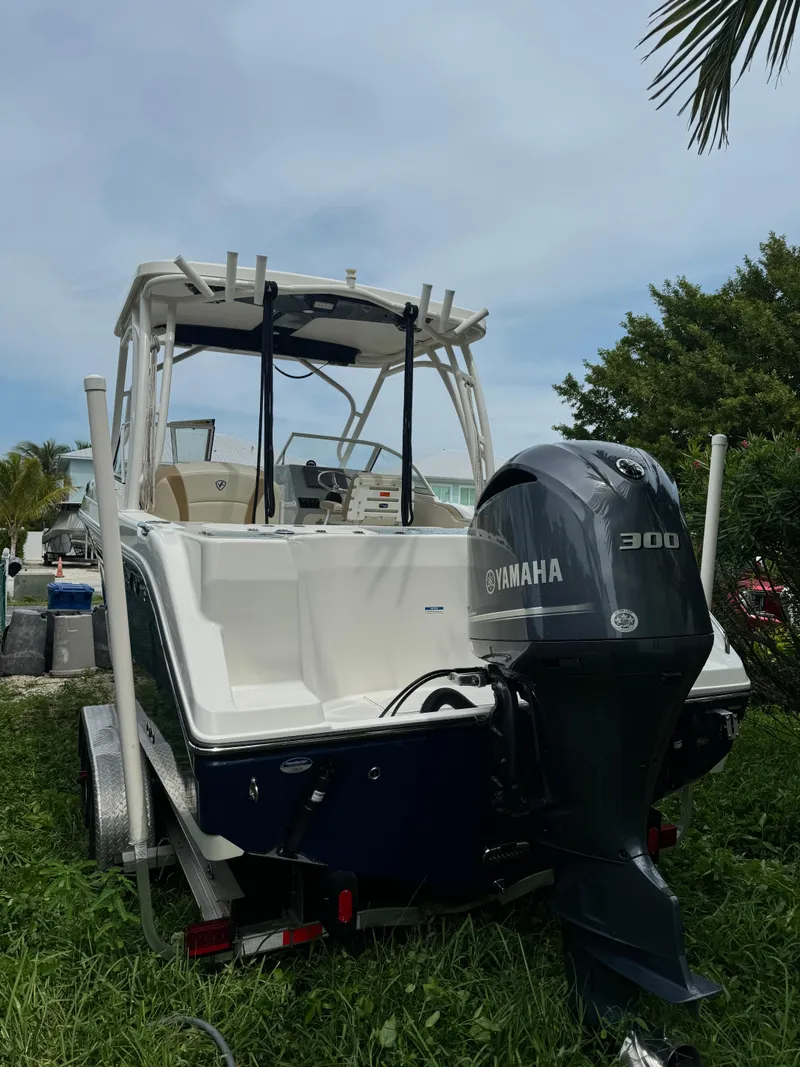 Slide: The Image of 2016 Century 24 Resorter boat with Yamaha 300 engine, parked on grass. - 4