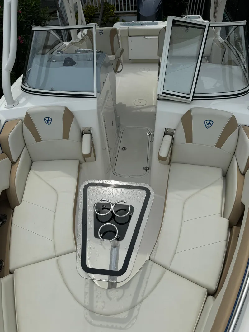 Slide: The Image of 2016 Century 24 Resorter boat interior with beige seating and cup holders. - 9