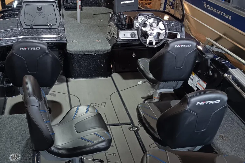 Slide: The Image of Interior of 2025 Nitro ZV20 boat with four black seats and modern dashboard. - 5