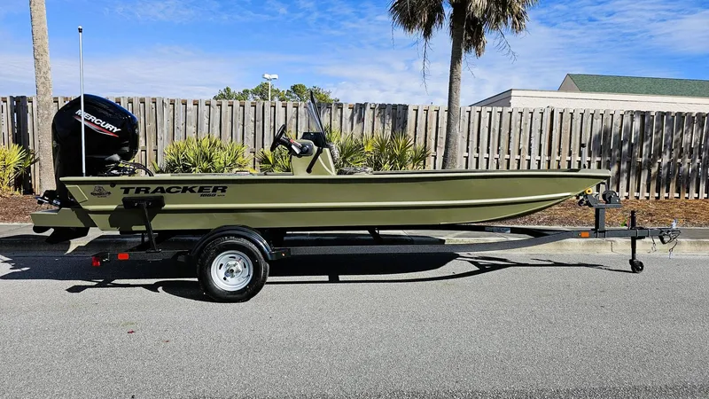Slide: The Image of 2025 Tracker Grizzly 1860 CC boat on trailer, parked outdoors. - 13