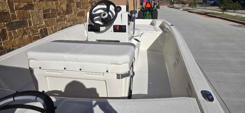 Slide: The Image of 2025 Mako Pro Skiff 15 CC boat interior with steering console and seating. - 3