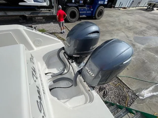 Slide: The Image of 2018 Pursuit 265 DC boat with dual Yamaha 200 engines in a marina setting. - 10