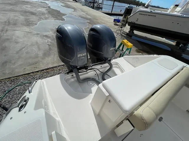 Slide: The Image of 2018 Pursuit 265 DC boat with twin 200 horsepower engines at a marina. - 11