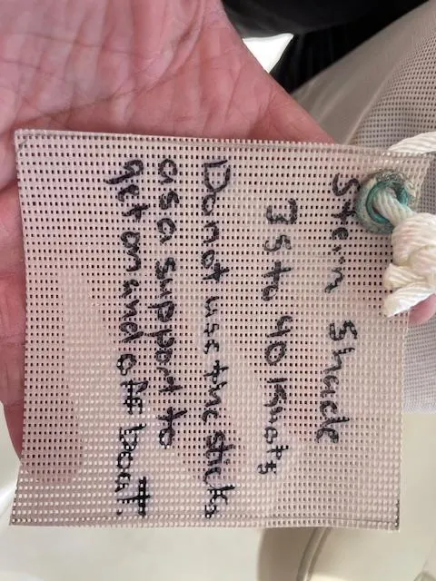 Slide: The Image of Hand holding a safety tag with handwritten instructions for a Pursuit 265 DC boat. - 23