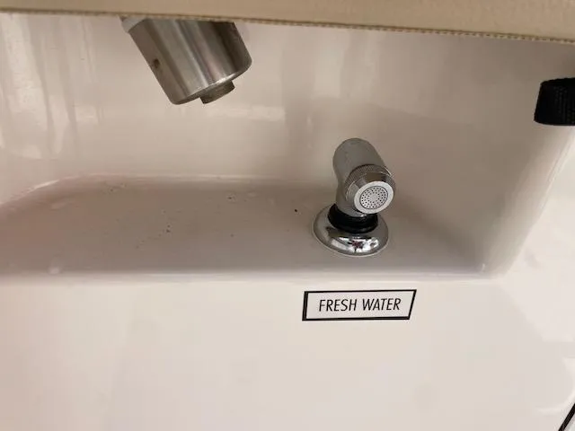 Slide: The Image of Fresh water outlet on 2018 Pursuit 265 DC boat. - 25