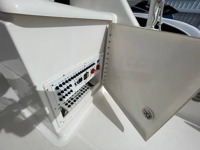 Slide: The Image of 2018 Pursuit 265 DC boat electrical panel with open access door. - 29