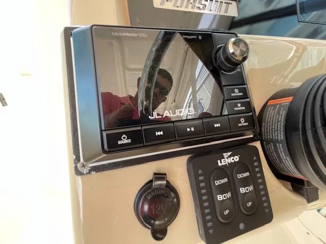 Slide: The Image of Control panel of 2018 Pursuit 265 DC boat with JL Audio system and Lenco trim tabs. - 34