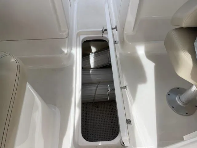 Slide: The Image of Open storage compartment on 2018 Pursuit 265 DC boat interior. - 39