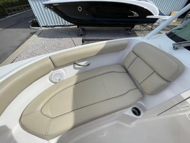 Slide: The Image of 2018 Pursuit 265 DC boat with beige leather seating in the bow area. - 41