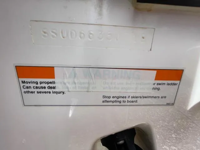 Slide: The Image of Warning label on 2018 Pursuit 265 DC boat about propeller safety and engine operation. - 7