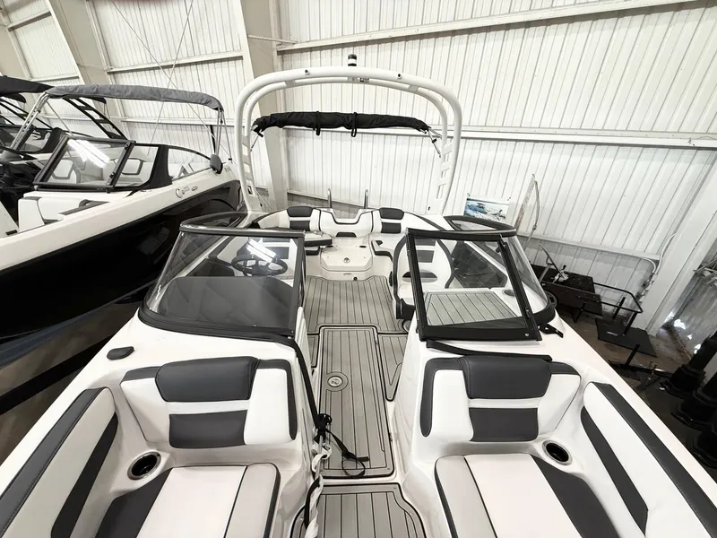 Slide: The Image of 2025 Yamaha Boats 195S interior with sleek seating and modern design in a showroom. - 5