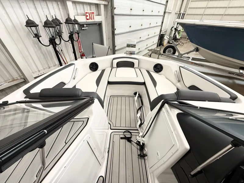 Slide: The Image of 2025 Yamaha Boats 195S interior, featuring sleek seating and modern design in a showroom setting. - 6