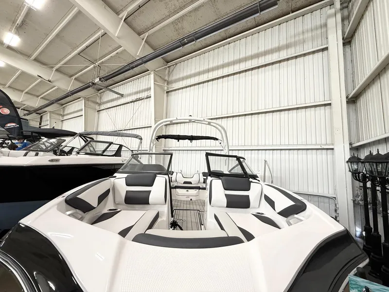 Slide: The Image of 2025 Yamaha Boats 195S in showroom, featuring sleek design and modern seating. - 8