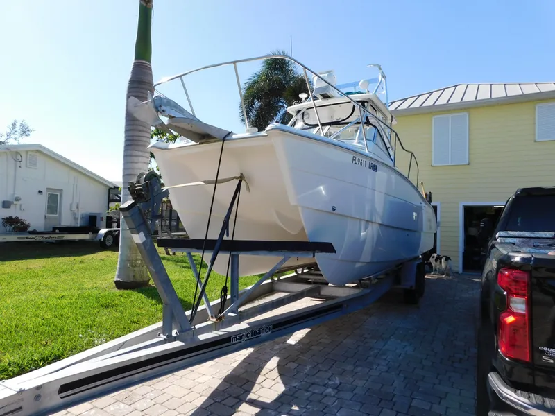 Slide: The Image of 2002 Sport-Craft 272 Sportfish boat on trailer in driveway. - 0