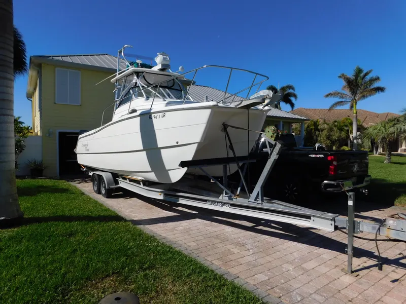 Slide: The Image of 2002 Sport-Craft 272 Sportfish boat on trailer in residential driveway. - 1
