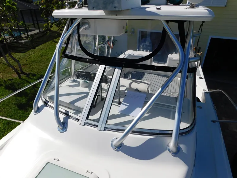 Slide: The Image of 2002 Sport-Craft 272 Sportfish boat with sleek windshield and sturdy metal frame. - 10