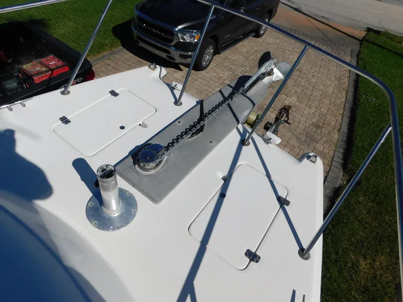 Slide: The Image of 2002 Sport-Craft 272 Sportfish boat deck with anchor chain and storage hatches. - 13