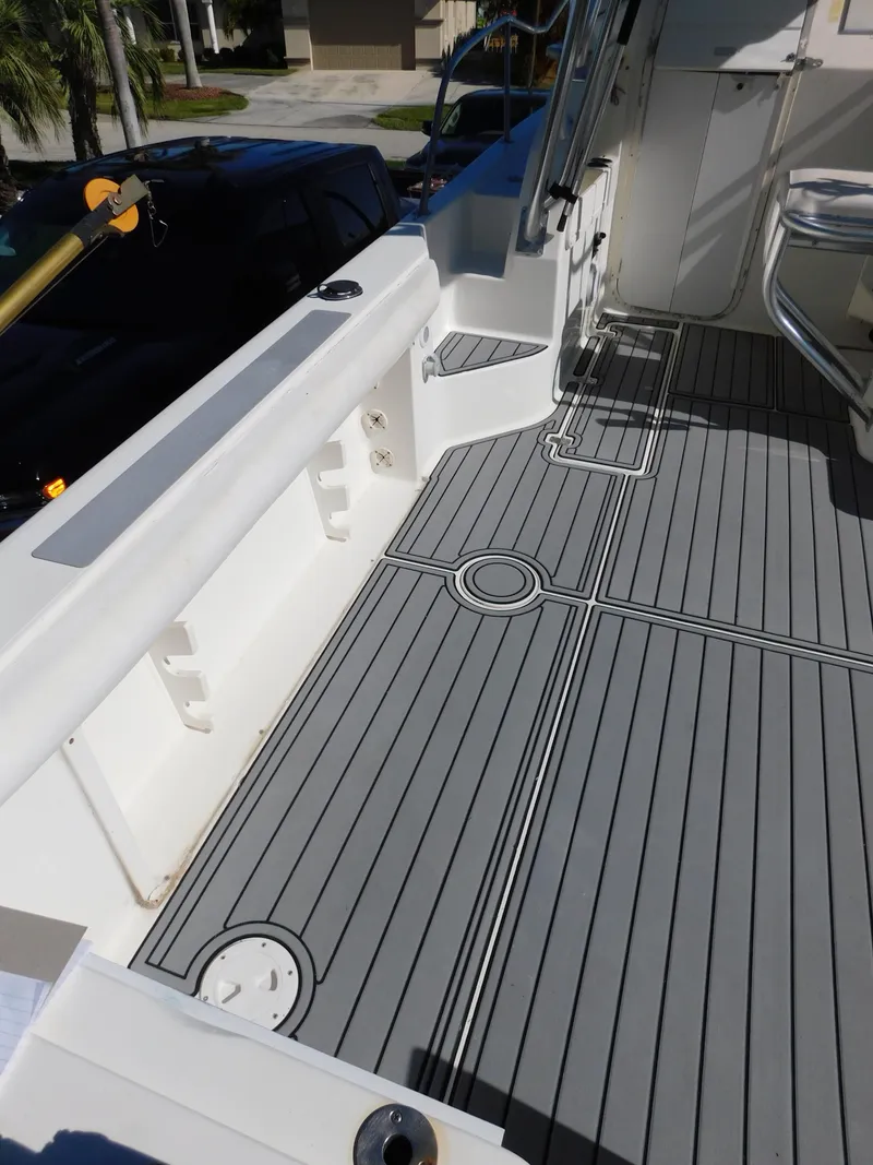 Slide: The Image of 2002 Sport-Craft 272 Sportfish boat deck with gray non-slip flooring. - 15
