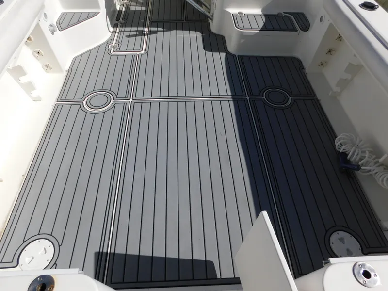 Slide: The Image of 2002 Sport-Craft 272 Sportfish boat deck with gray non-slip flooring. - 16