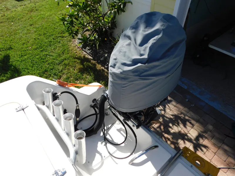 Slide: The Image of Covered outboard motor on 2002 Sport-Craft 272 Sportfish boat, with rod holders. - 18