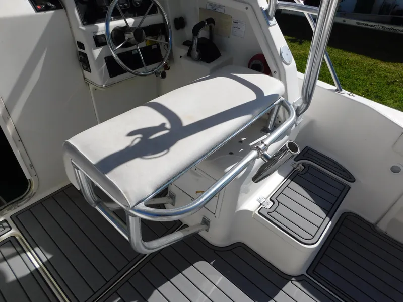 Slide: The Image of 2002 Sport-Craft 272 Sportfish boat interior with steering wheel and seating area. - 20