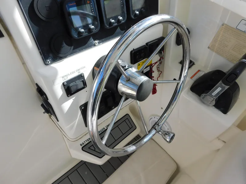 Slide: The Image of 2002 Sport-Craft 272 Sportfish boat steering wheel and control panel. - 23
