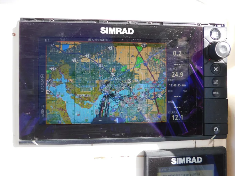 Slide: The Image of Simrad navigation system on 2002 Sport-Craft 272 Sportfish boat displaying nautical map. - 26