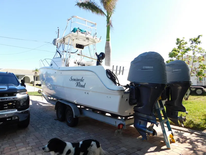 Slide: The Image of 2002 Sport-Craft 272 Sportfish boat on trailer with twin Yamaha engines. - 3