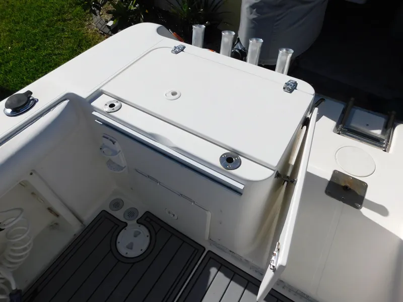 Slide: The Image of 2002 Sport-Craft 272 Sportfish boat deck with storage compartments and rod holders. - 30