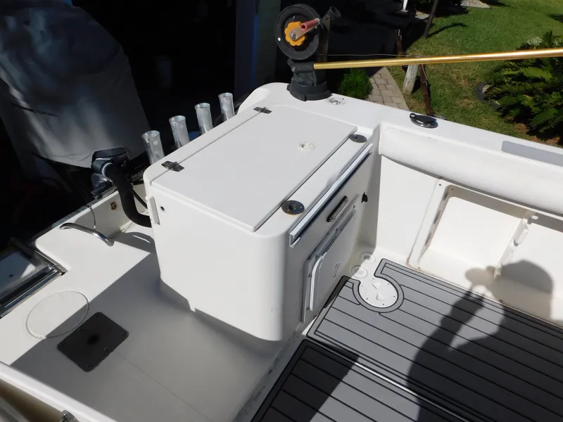 Slide: The Image of 2002 Sport-Craft 272 Sportfish boat deck with storage and rod holders. - 31