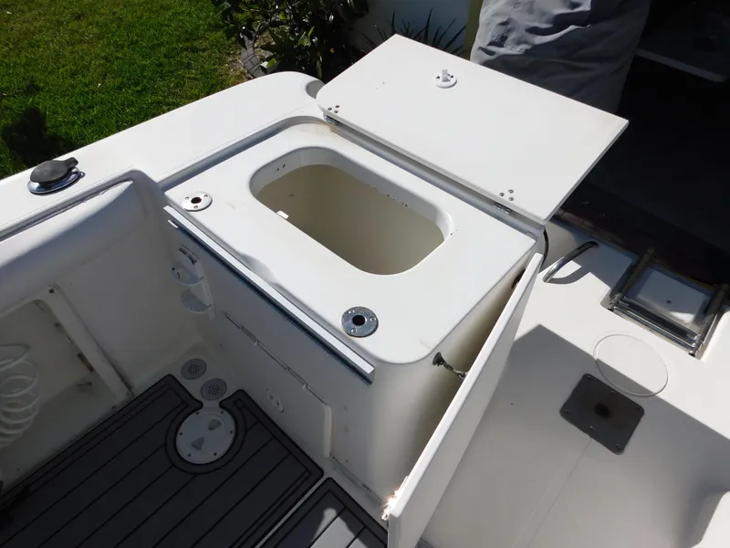 Slide: The Image of 2002 Sport-Craft 272 Sportfish boat deck with open storage compartment. - 33