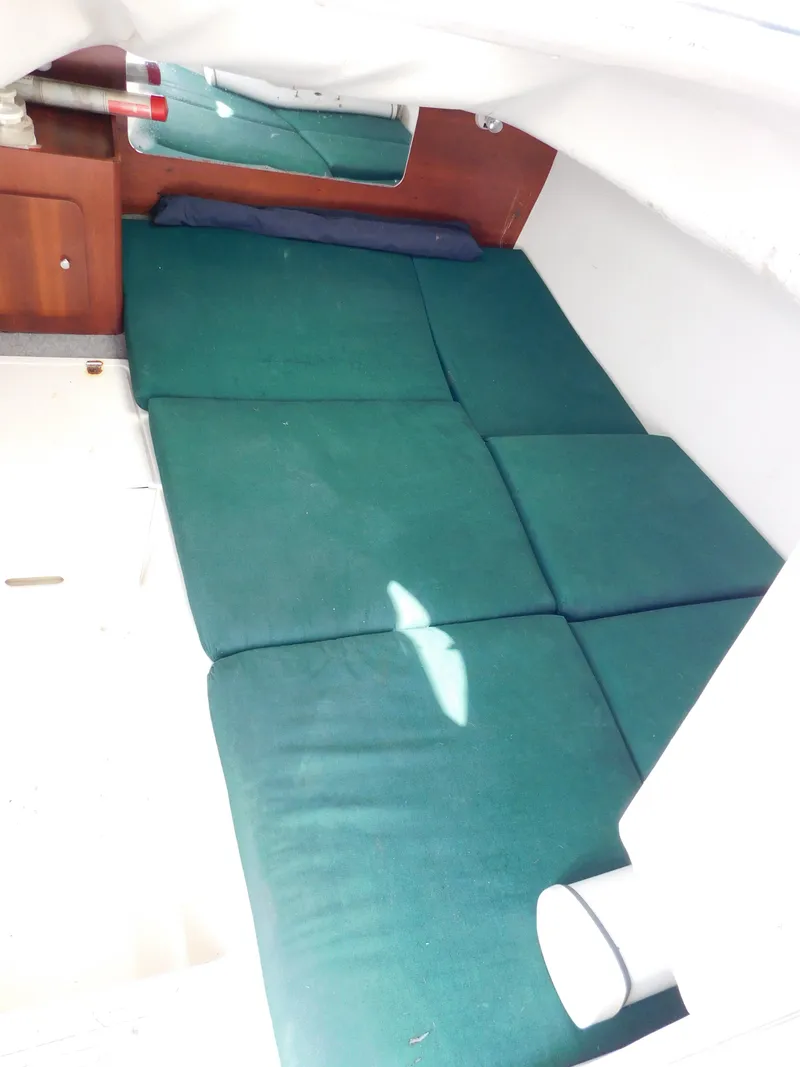 Slide: The Image of 2002 Sport-Craft 272 Sportfish cabin interior with green cushions and wooden cabinetry. - 35