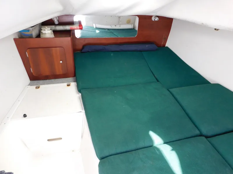 Slide: The Image of Interior cabin of 2002 Sport-Craft 272 Sportfish with green cushions and wooden accents. - 36