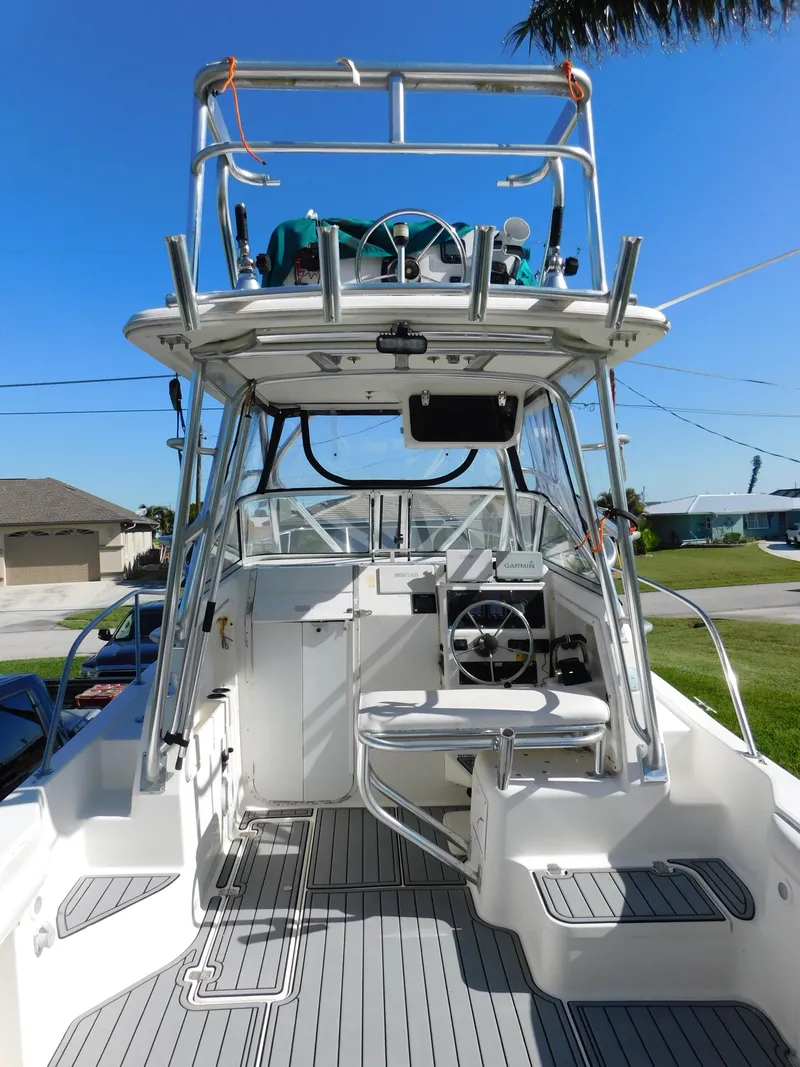 Slide: The Image of 2002 Sport-Craft 272 Sportfish boat with dual helm, spacious deck, and modern controls. - 5