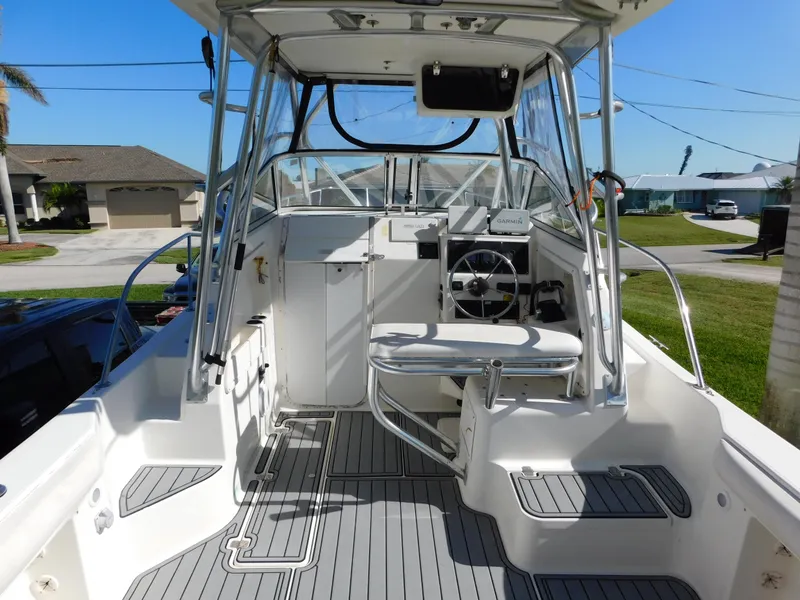 Slide: The Image of 2002 Sport-Craft 272 Sportfish boat interior with steering wheel and seating. - 6