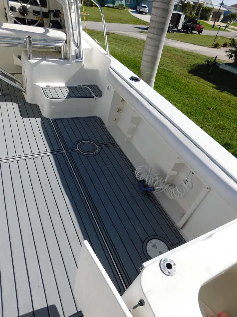 Slide: The Image of 2002 Sport-Craft 272 Sportfish boat deck with seating and storage compartments. - 9