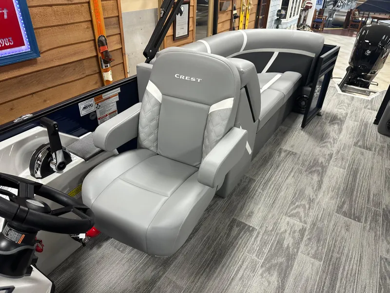 Slide: The Image of 2025 Crest Classic 220 boat interior with gray seating and modern design. - 10
