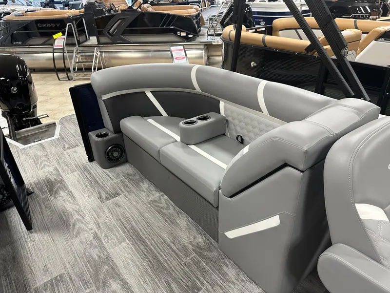 Slide: The Image of 2025 Crest Classic 220 boat interior with gray seating and modern design. - 11