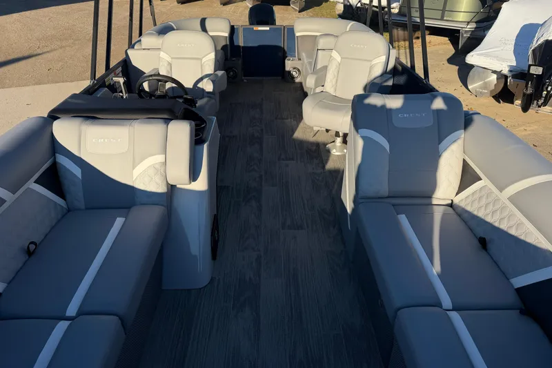 Slide: The Image of 2025 Crest Classic 220 boat interior with gray seating and modern design. - 16