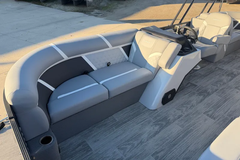 Slide: The Image of 2025 Crest Classic 220 pontoon boat interior with gray seating and modern design. - 18