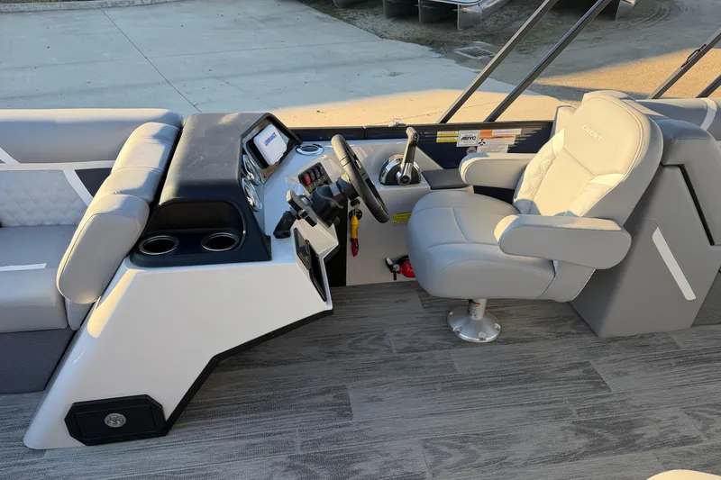 Slide: The Image of 2025 Crest Classic 220 boat interior with modern helm and comfortable seating. - 19