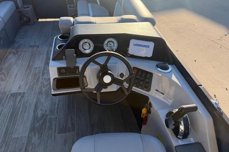 Slide: The Image of 2025 Crest Classic 220 boat dashboard with steering wheel and navigation system. - 21