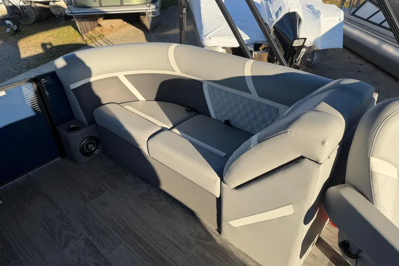 Slide: The Image of 2025 Crest Classic 220 boat interior with gray cushioned seating and modern design. - 25