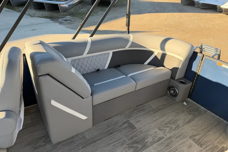 Slide: The Image of 2025 Crest Classic 220 boat interior with stylish gray seating and wood-patterned flooring. - 26