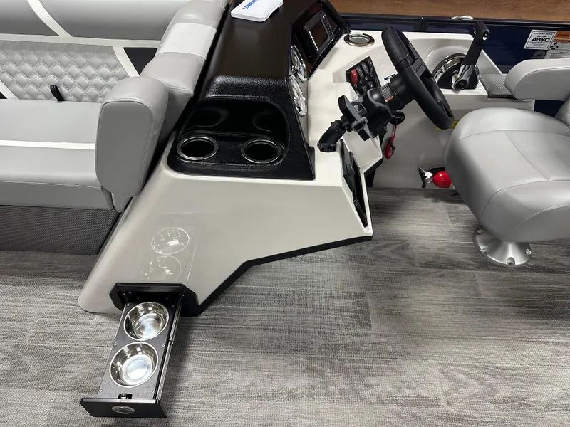 Slide: The Image of 2025 Crest Classic 220 boat interior with steering wheel and cup holders. - 5