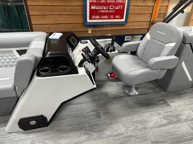 Slide: The Image of 2025 Crest Classic 220 boat interior with steering console and seating. - 6